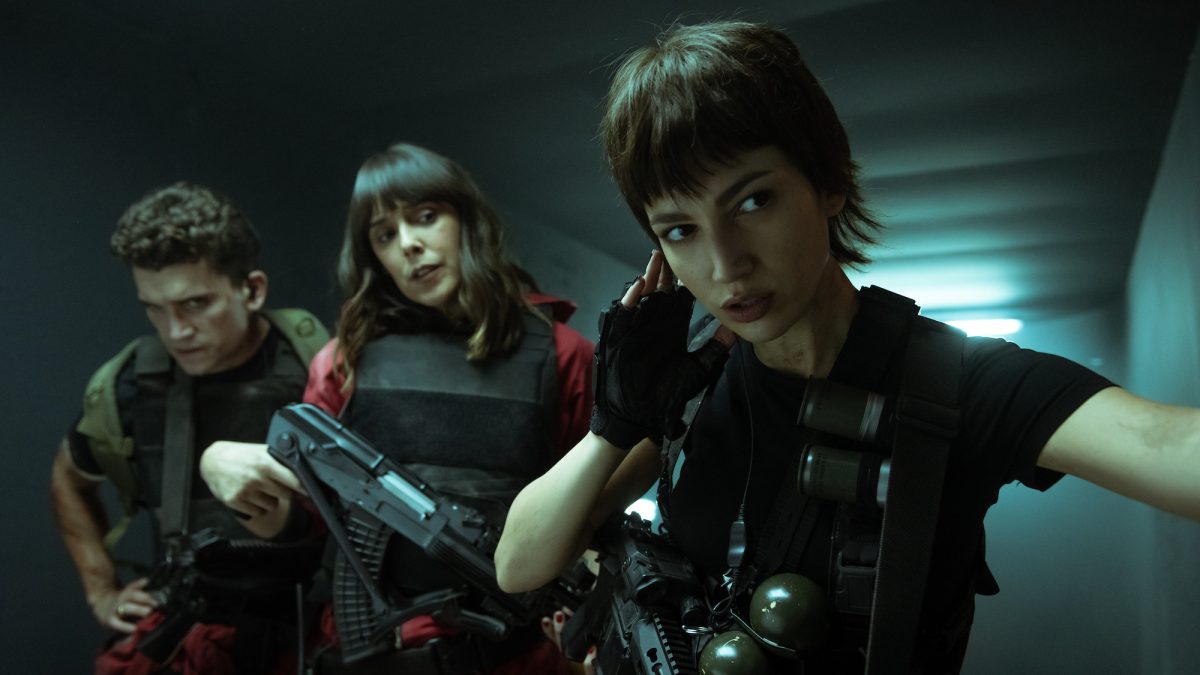Jamie Lorente, Belén Cuesta, and Úrsula Corberó dressed in red and black gear in Netflix
