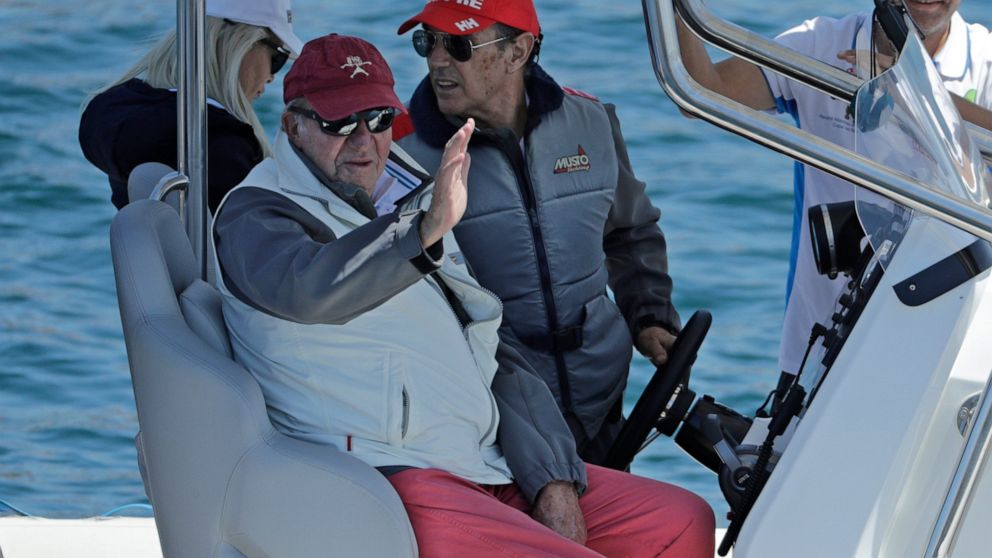 Spain's former King Juan Carlos, 2nd left, waves from a support launch that will accompany the Bribon yacht during a 'regatta' race between yachts in Sanxenxo, north western Spain, Friday, May 20, 2022. Spain's former King has returned to Spain for h