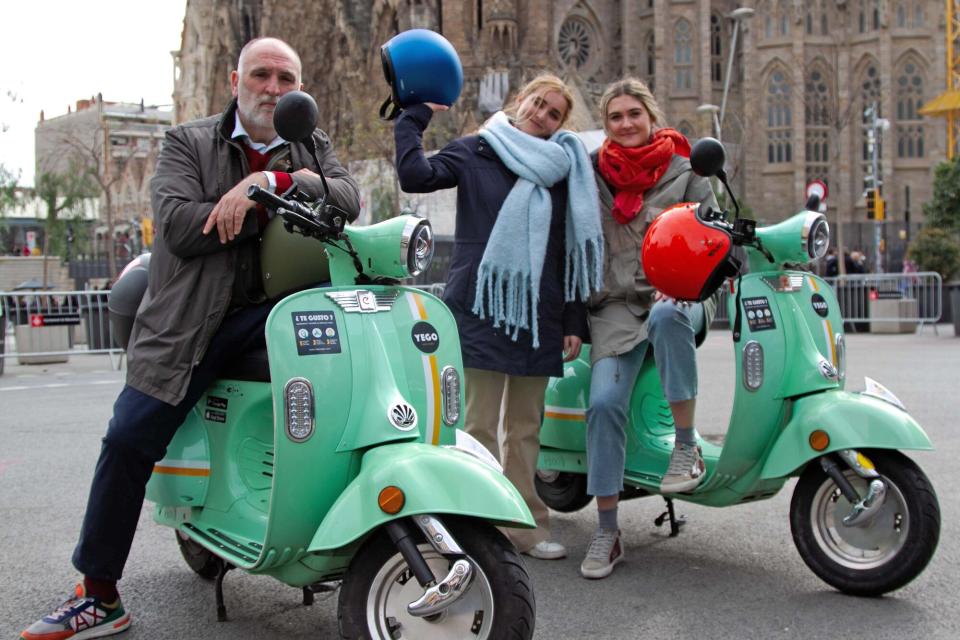 Presenta a Jose Andres, Carlota Andres e Ines Andres en scooters frente a La Sagrada Familia, Cataluña, como se ve en Jose Andres and Family en España.